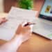 pexels-alexandr-podvalny - femme regardant facture - 5 astuces pour diminuer ta facture energie