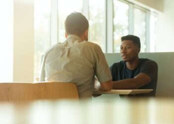 unsplash - LinkedIn sales solutions - deux hommes qui parlent autour d'une table - les 7 pires conseils qu'on t'a déjà donnés quand tu étais triste