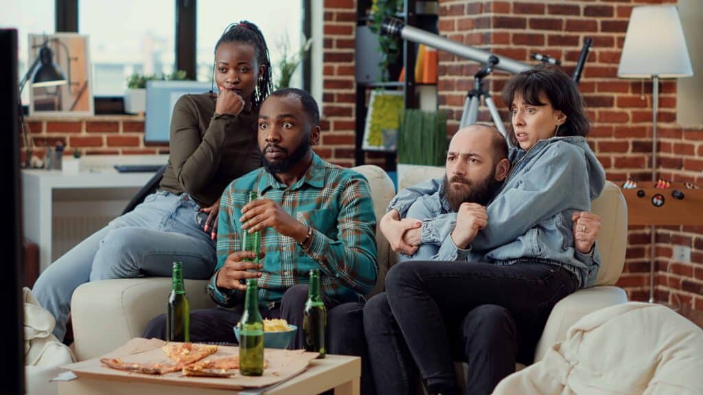 freepik - Diverse friends being scared watching horror movie