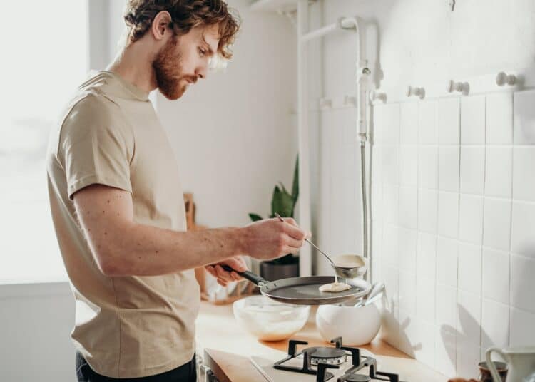pexels-cottonbro-studio-jeune qui cuisine - 5 choses que tu dois avoir dans ta cuisine si tu vis en kot
