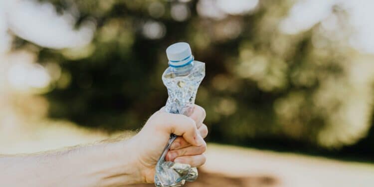 pexels-karolina-grabowska-écraser une bouteille en plastique dans ma main-Comment réduire ton empreinte carbone