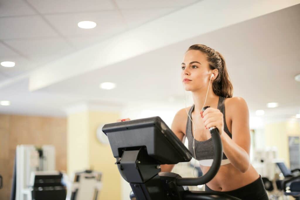 pexels-olly- femme faisant du vélo - Comment garder un rythme constant à la salle de sport ? .jpg