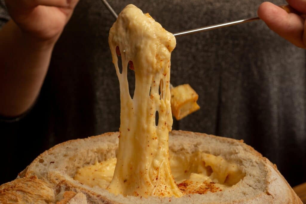 pexels-gonzalo-acuna-fromages fondant et coulant dans une fondue-Pourquoi faire une fondue savoyarde au kot