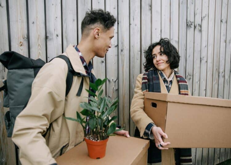 pexels-ivan-samkov-deux étudiant avec des cartons en main et des plantes-Quitter son kot pendant l’été, que faire de ses affaires ?