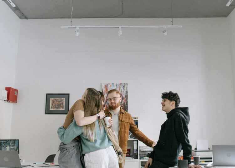 pexels-ivan-samkov-jeunes travailleurs qui se font des calins -Comment fêter son premier job avec ses ami•e•s ?