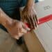 pexels-rdne-personne qui ferme un carton de déménagelent-10 indispensables à avoir dans son kot pour un premier aménagement